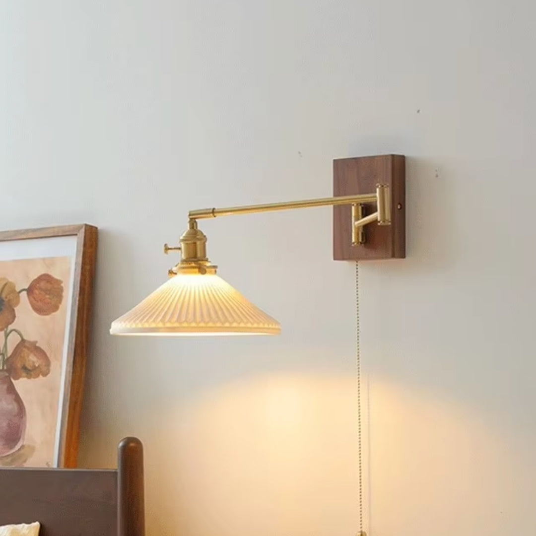 Close-up of the swing arm sconce light fixture, showcasing the elegant metal design and high-quality finish