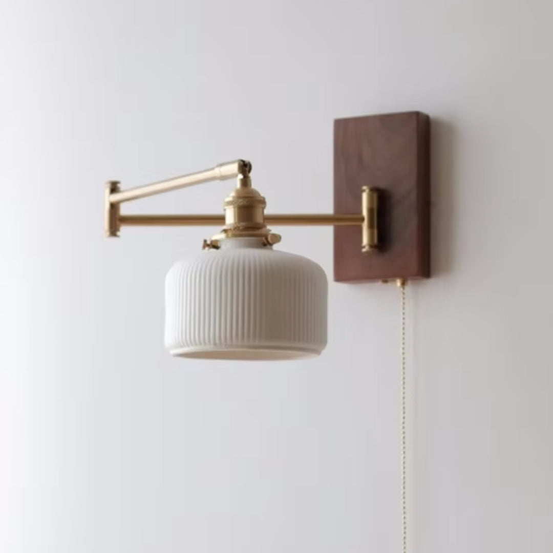 Swing arm sconce in a cozy bedroom, adjustable for reading or ambient lighting.