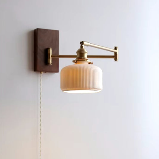 Wall-mounted swing arm sconce in a living room, providing targeted lighting with a chic design.