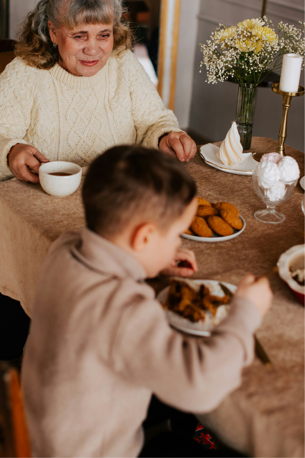 A warm, inviting living room where a family enjoys quality time together, with soft, ambient light from stylish sconces casting a cozy glow on the scene. The perfect atmosphere for family gatherings with elegant wall sconces that enhance home decor and lighting.