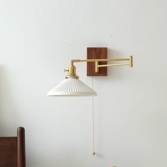 Swing arm sconce wall lamp in modern interior design, fully extended to show adjustable arm and sleek metal finish.